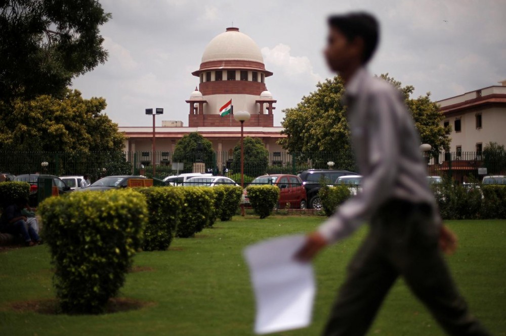 FILE PHOTO: A man walks inside the premises of the Supreme Court in New Delhi, India, July 17, 2018. REUTERS/Adnan Abidi/File photo